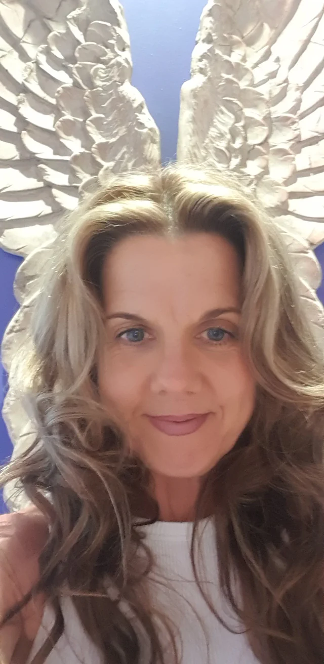 Jasmyn Ward in front of angel-wing artwork